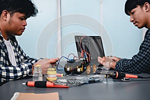 Engineer Asian Students Assembling Robotics Kits. Learning Mechanical Control by Computer, Robotics combines computer, electrical