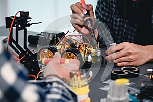 Engineer Asian Students Assembling Robotics Kits. Learning Mechanical Control, Robotics combines computer, electrical, mechanical