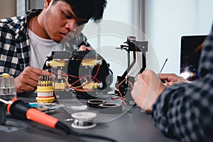 Engineer Asian Students Assembling Robotics Kits. Learning Mechanical Control, Robotics combines computer, electrical, mechanical