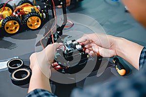 Engineer Asian Students Assembling Robotics Kits. Learning Mechanical Control, Robotics combines computer, electrical, mechanical