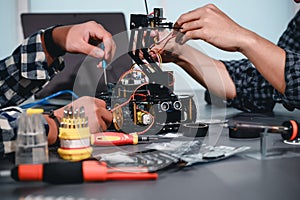 Engineer Asian Students Assembling Robotics Kits. Learning Mechanical Control, Robotics combines computer, electrical, mechanical