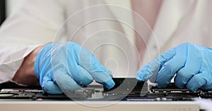 Engineer assembling a printed circuit board in workshop