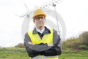 Engineer on a background of power line tower