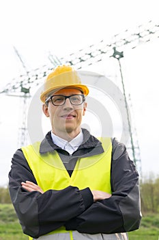 Engineer on a background of power line tower