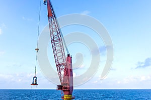 An engineer being transferred from a boat to a construction work barge using personal basket transfer