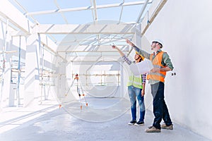 Engineer builder architect team working check  progress construction of the roof structure of the building