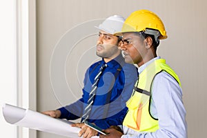 engineer builder team working with architect designer work inspect large building factory construction project with floorplan