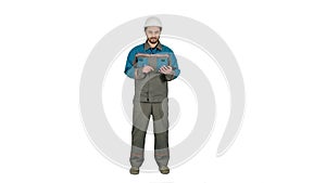 Engineer builder using tablet and walkie talkie, giving instructions at a construction site on white background.