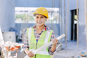 Engineer builder woman worker foreman. Portrait Asian girl architect home designer with floor plan