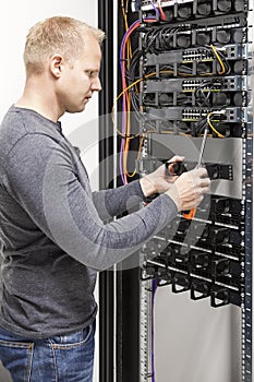 IT engineer builds network rack in datacenter