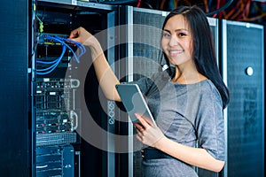 Engineer businesswoman in network server room