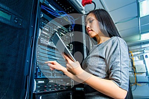 Engineer businesswoman in network server room photo