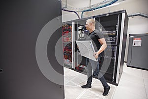 IT Engineer Carrying Blade Server While Walking In Datacenter