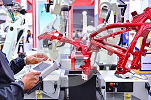 Engineer check and control automation Robot arm machine for Automotive structure of motorcycle
