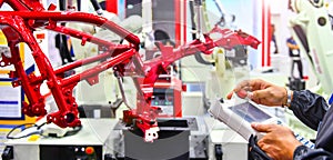 Engineer check and control automation Robot arm machine for Automotive structure of motorcycle