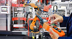 Engineer check and control modern high quality automation welding robots arm at industrial