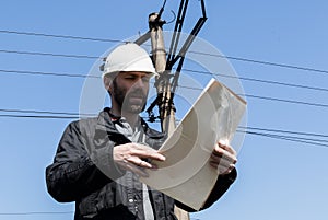 Engineer check electrical systems talk walkie-talkie, Inspector holding blueprints plan