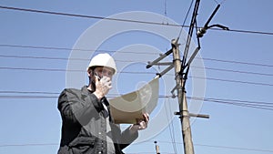 Engineer check electrical systems talk walkie-talkie, Inspector holding blueprints plan