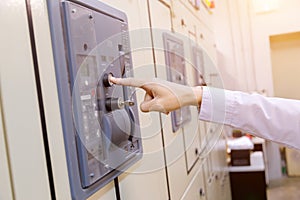 Engineer is check voltage or current by voltmeter in control panel of power plant. photo