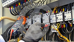 Engineer checking electric at circuit breaker and cable wiring