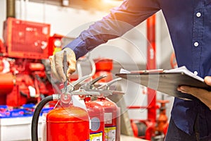 Engineer checking Industrial fire control system,are checking fire extinguishers.