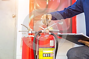 Engineer checking Industrial fire control system,are checking fire extinguishers.