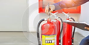 Engineer checking Industrial fire control system are checking fire extinguishers.