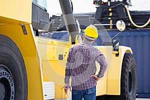 Engineer checking and inspect container in industry cargo, Foreman in hardhat helmet control loading containers box from cargo