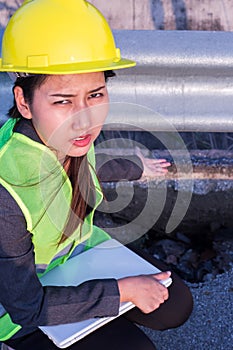 Engineer checking and showing damaged road asphalt concrete design