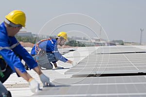 Engineer checking on solar panel on the factory rooftop