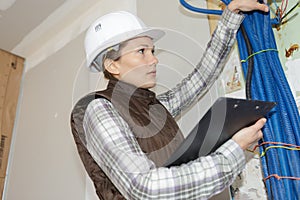 Engineer checking temperature pipes in construction site