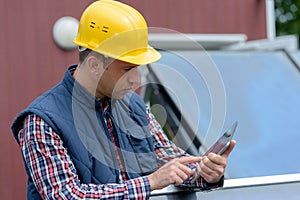 Engineer checks tablet operation in solar pannel