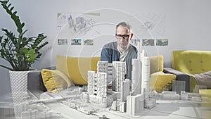 Engineer, client examines architectural maquette of apartments in mixed reality