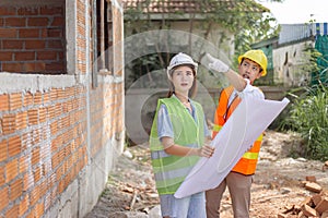 Engineer concept The male and female engineering coworkers looking and figuring out about the building construction