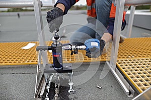 Engineer conducting using pull machinery testing chemical set fall arrest fall restraint abseiling anchor point photo