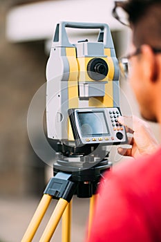 engineer on construction site, working with total station theodolite and gps system