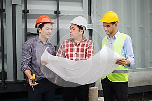 Engineer and construction team wearing safety helmet and blueprint on hand. engineer and client checking construction process