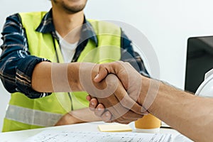 Engineer construction worker team hands shaking after plan project contract