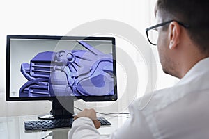 Engineer, Constructor, Designer, Architect in Glasses Working on a Personal Computer. He Creating New Component in CAD