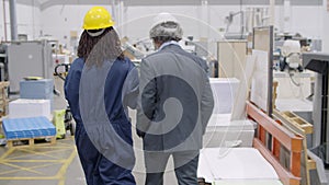 Engineer consulting Black female factory worker