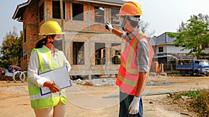 Engineer contractor team meeting work safety plan industry project and check design at the construction building site