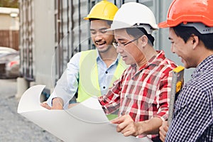 Engineer, contractor, worker teamwork. Group of construction people look at blueprint together  and planning work schedule