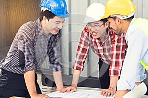 Engineer, worker teamwork. Group of construction people look at blueprint together  and planning work schedule