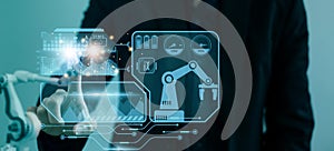 Engineer control automated robot arm machine in factory,smart visual interface screen artificial intelligence or AI,machine