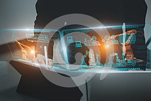 Engineer control automated robot arm machine in factory,smart visual interface screen artificial intelligence or AI,machine