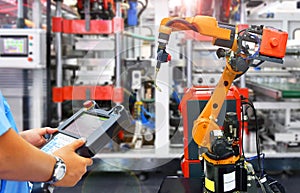 Engineer control modern high quality automation welding robots arm at industrial