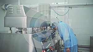 Engineer control pharmaceutical manufacturing. Factory worker operating pharmaceutical equipment. Pharmacy industry