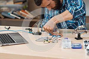 Engineer creating electronic construction at lab