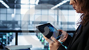 Engineer in data center with tablet integrating AI driven automation tools