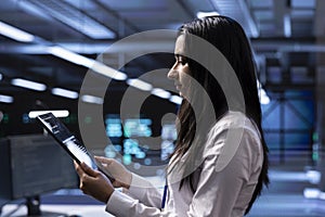 Employee looking for errors causing servers to slow down using tablet